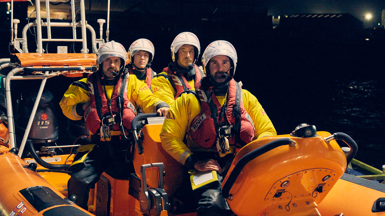 Four RNLI crew members from Great Yarmouth and Gorleston onboard their inshore lifeboat. It’s a dark night. 