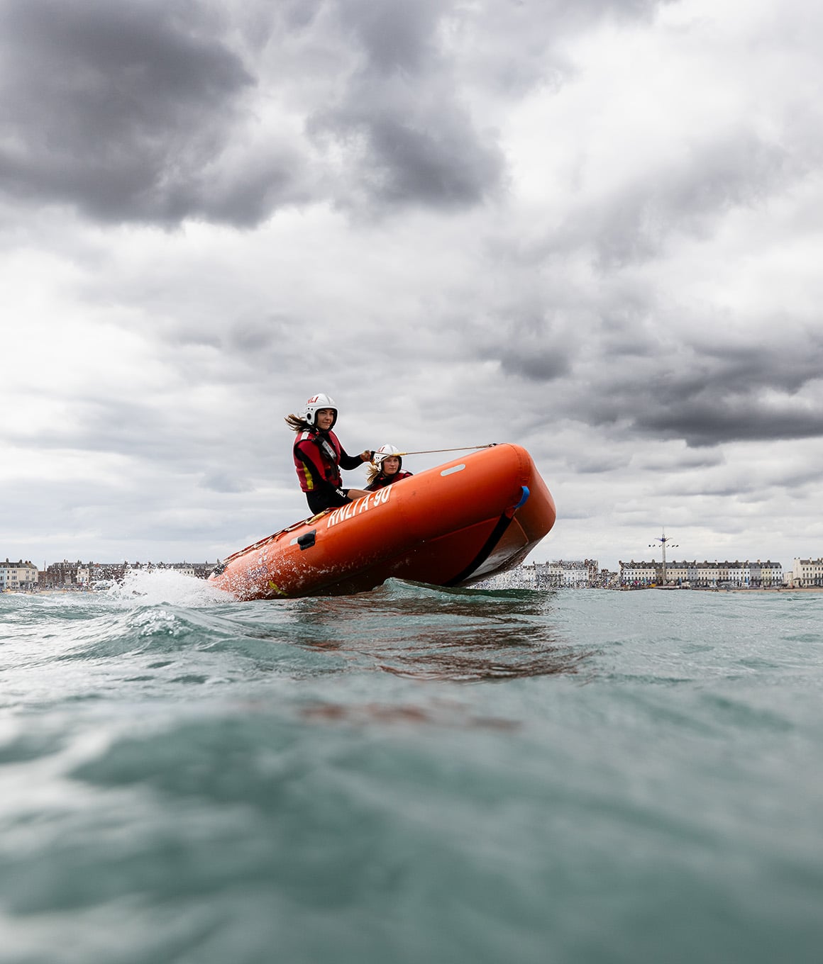 Senior Lifeguards aboard an RNLI inshore rescue boat.
