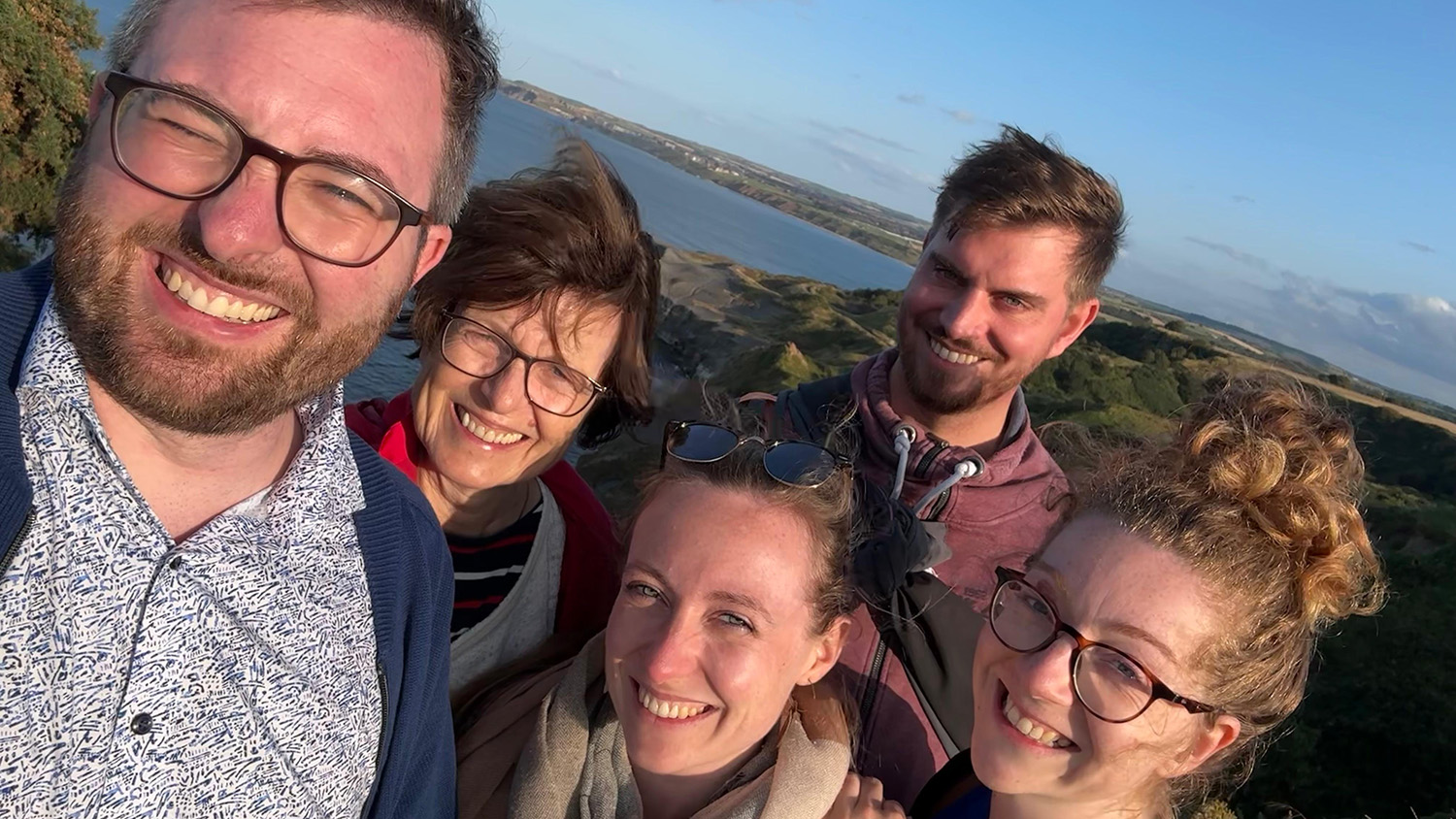 Carolin and four members of her family gather and smile on the coast path near Whitby.
