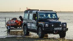 The INEOS Grenadier launch vehicle launching a D class lifeboat at the beach.