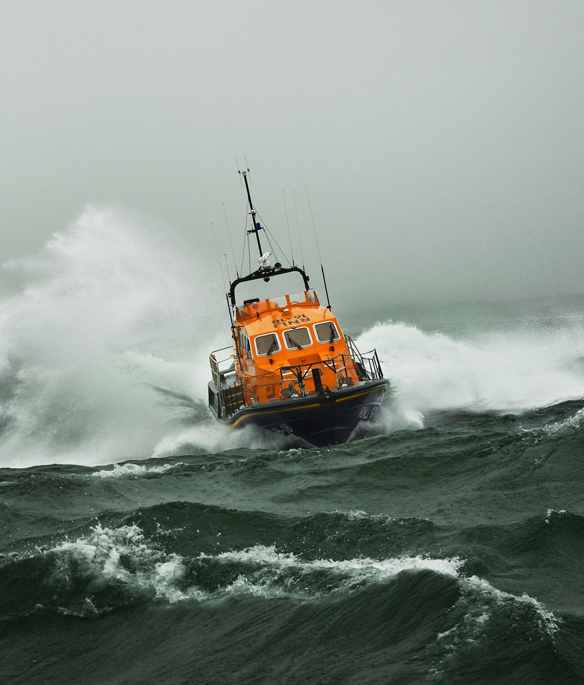 Kilmore Quay's Tamar class lifeboat in rough seas, with lots of sea spray.
