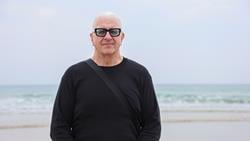 Mark Ferrer - who was rescued by RNLI lifeguards - standing on a beach, facing camera. Photo: RNLI/Charlotte Hill.