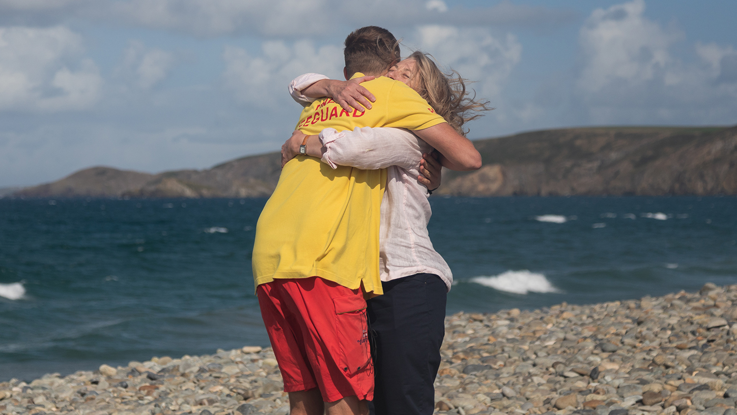 Lifeguard Matty hugs Joanna on the beach. It's an emotional reunion. 