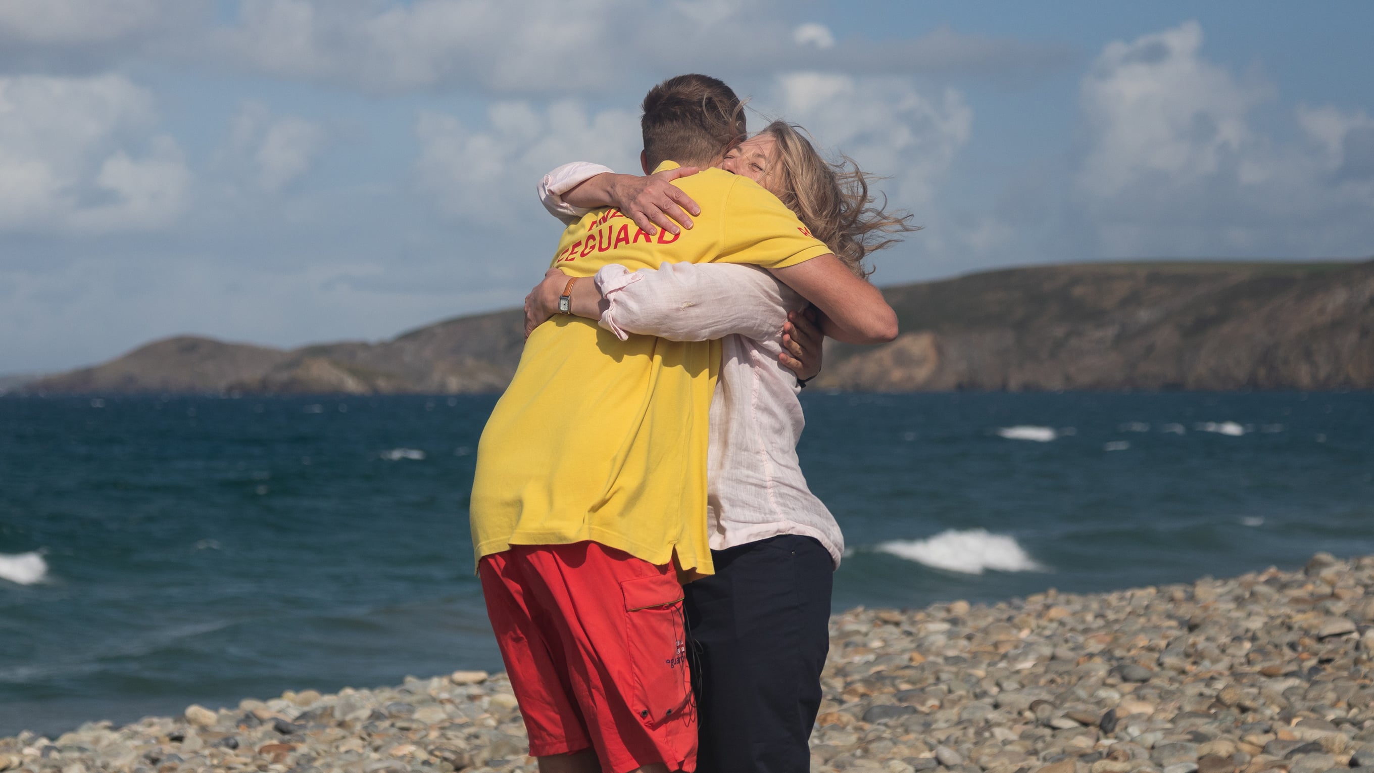 Lifeguard Matty hugs Joanna on the beach. It's an emotional reunion. 