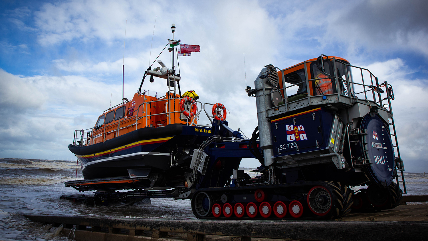 Rhyl RNLI’s Shannon class all-weather lifeboat being launched on the beach by the Shannon Launch and Recovery System and its shore crew drivers.