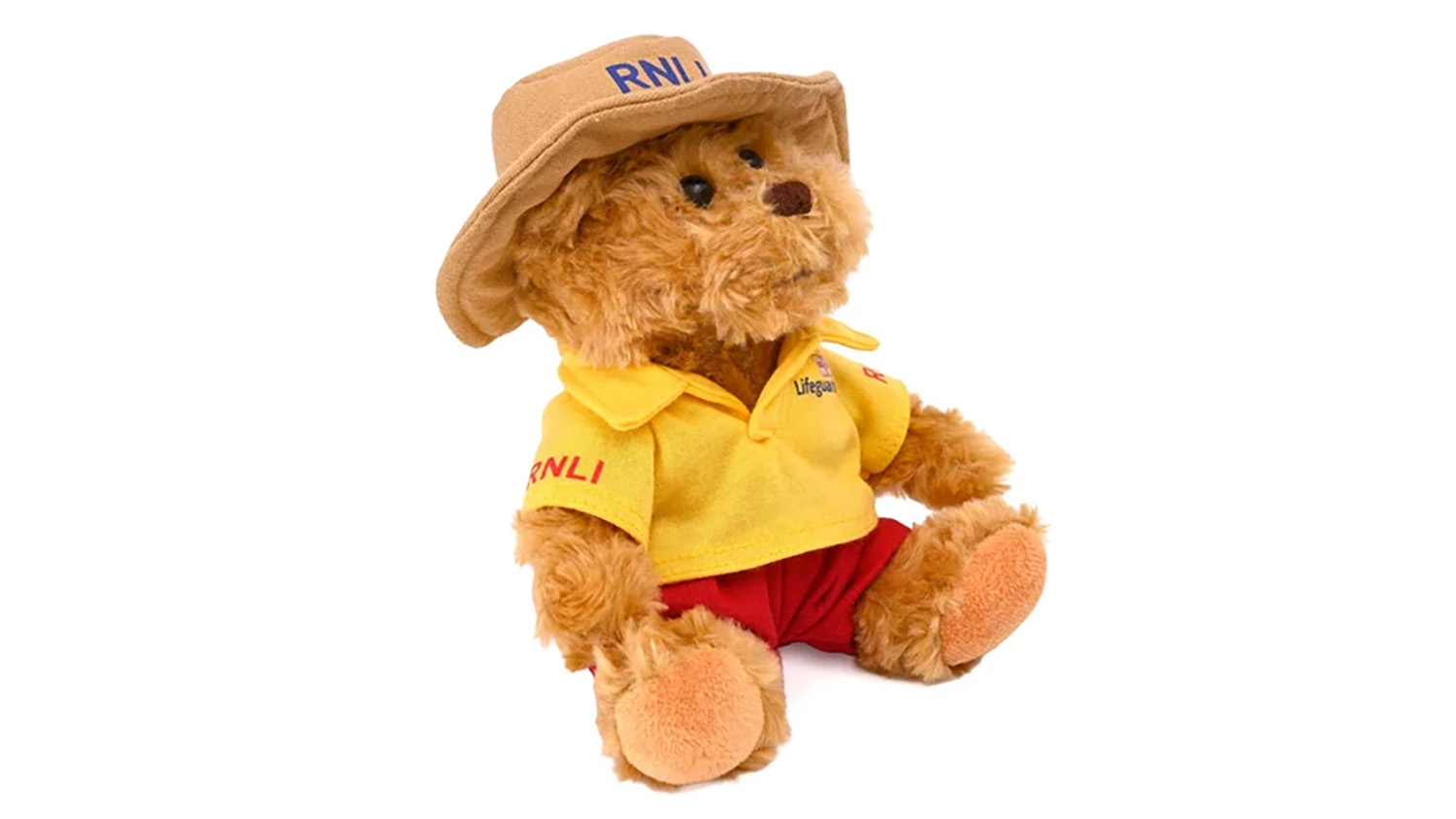 An RNLI lifeguard bear, sold at RNLI Shop, wearing a beige boonie hat, a yellow polo top and red shorts.