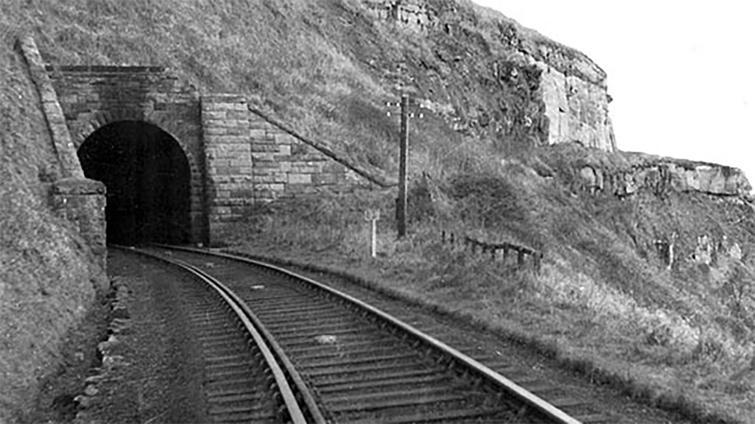 A black and white photograph of Sandsend railway and tunnel. 
