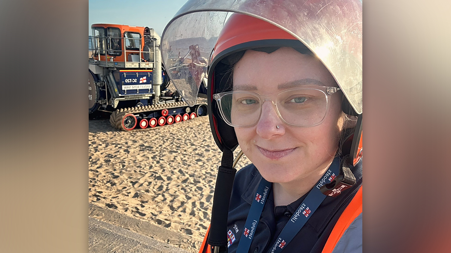 A head and shoulders shot of Rhyl RNLI Volunteer Shore Crew Member Terrie Jones, with the launching tractor in the background.