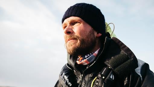 Tom Coe on the water in warm, protective gear. 
