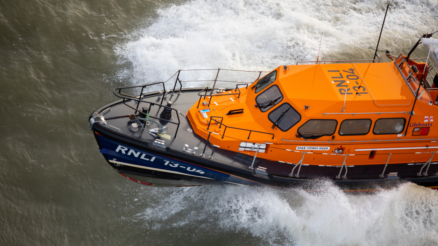 Aerial image of a Shannon class lifeboat crashing through waves