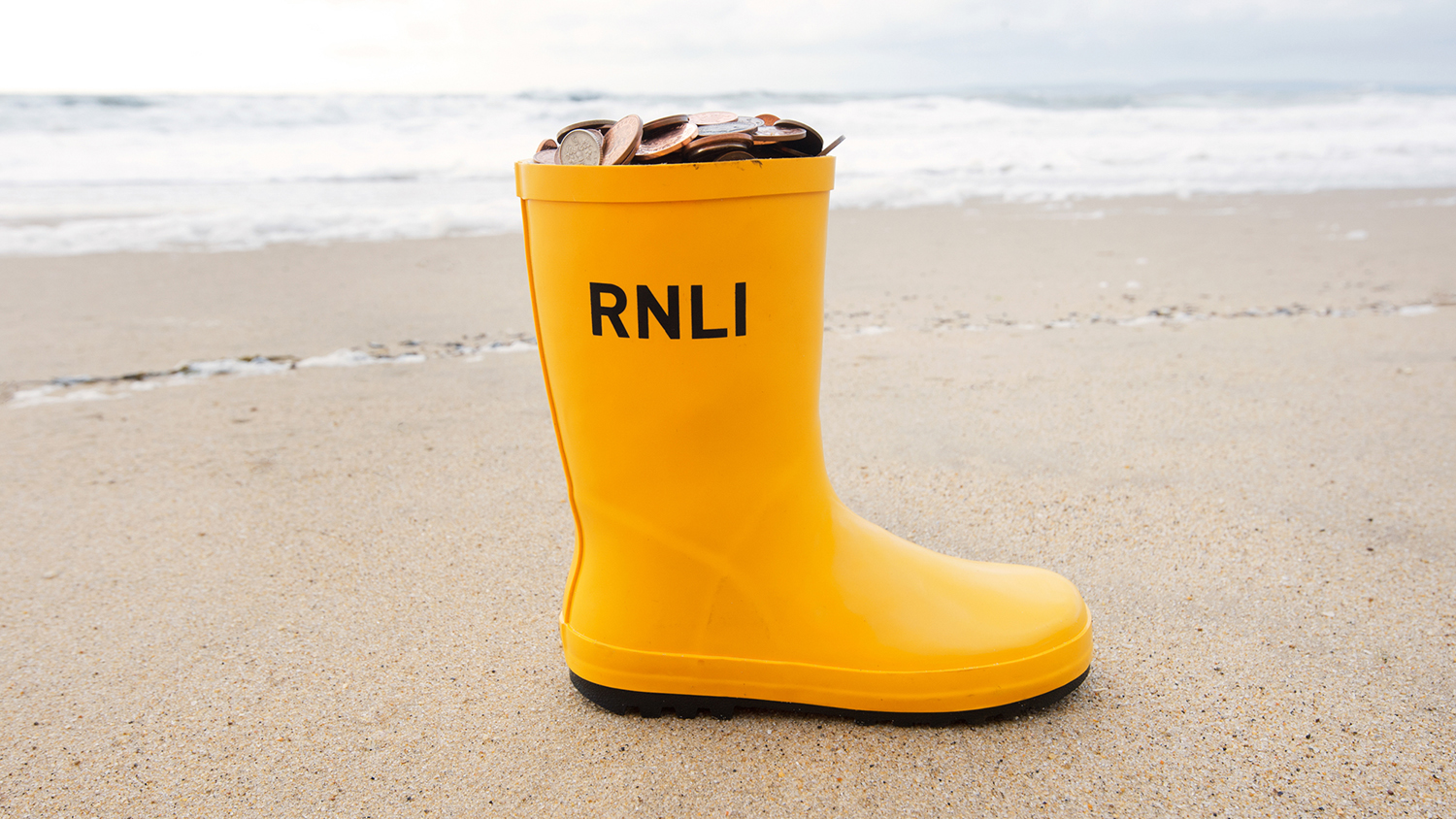 A yellow welly filled with coins