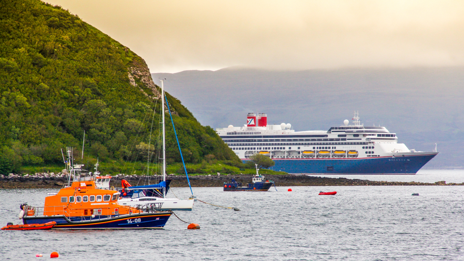Fred Olsen ship and RNLI boat on the water