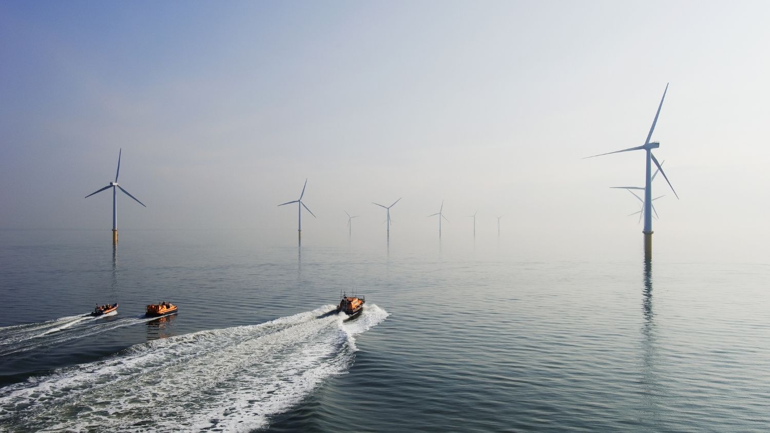 RNLI boats navigating between Ørsted wind farm in the ocean