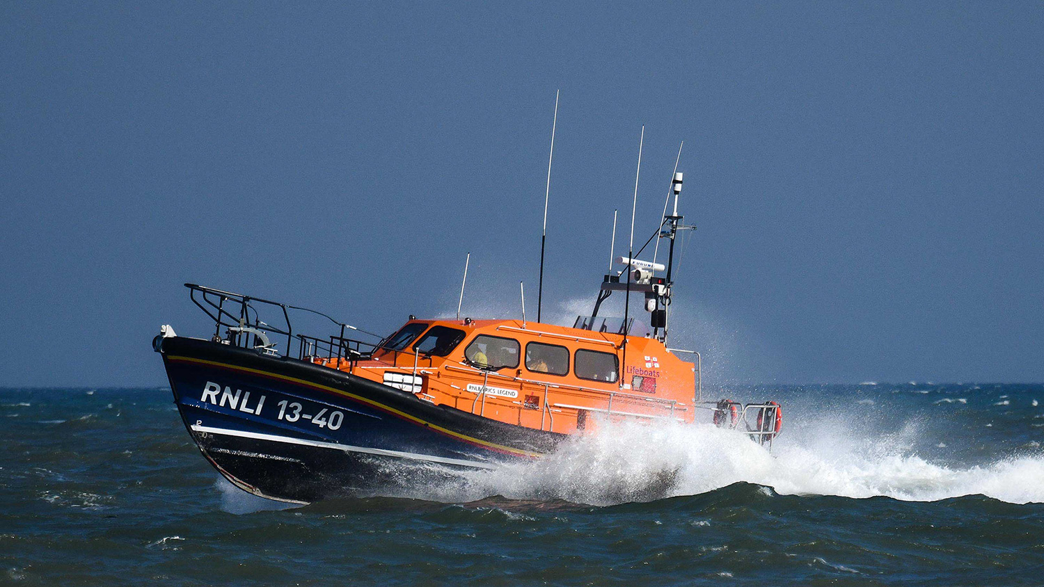RNLI Shannon class lifeboat Eric’s Legend at sea against a slate-grey sky
