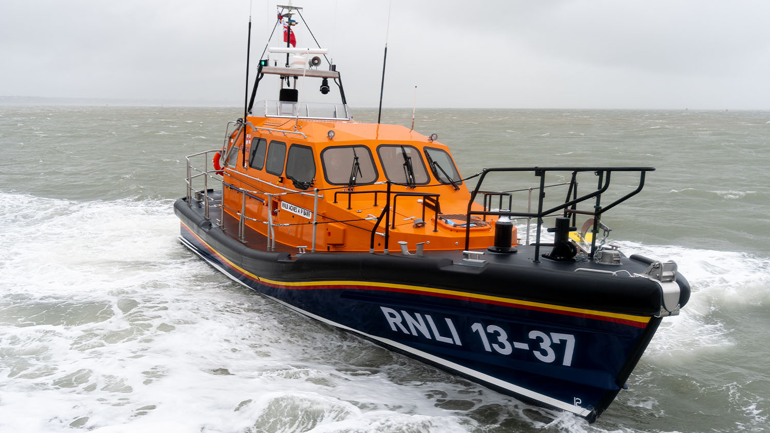 Invergordon RNLI’s Shannon class lifeboat Agnes AP Barr at sea, with the hull number 13-37 clearly visible.