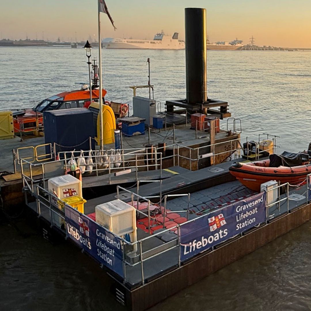 Gravesend Lifeboat Station and its floating pontoon on the River Thames at sunset.