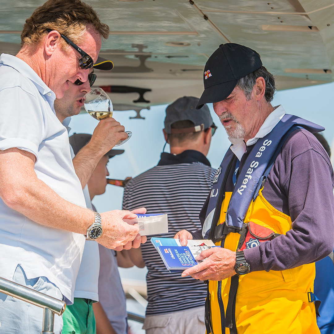 An RNLI volunteer speaking to a member of the public about water safety. 