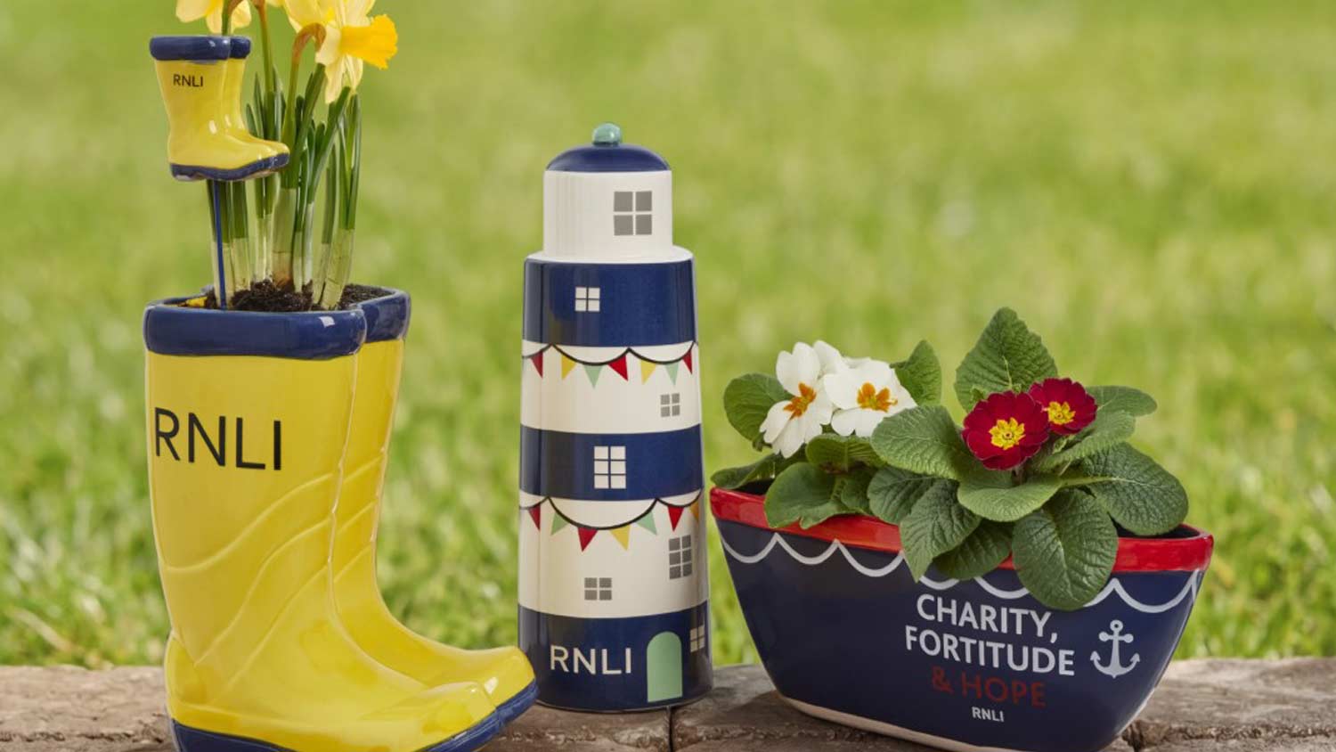 RNLI Mayday planters including a yellow welly, classic lifeboat and lighthouse ornament