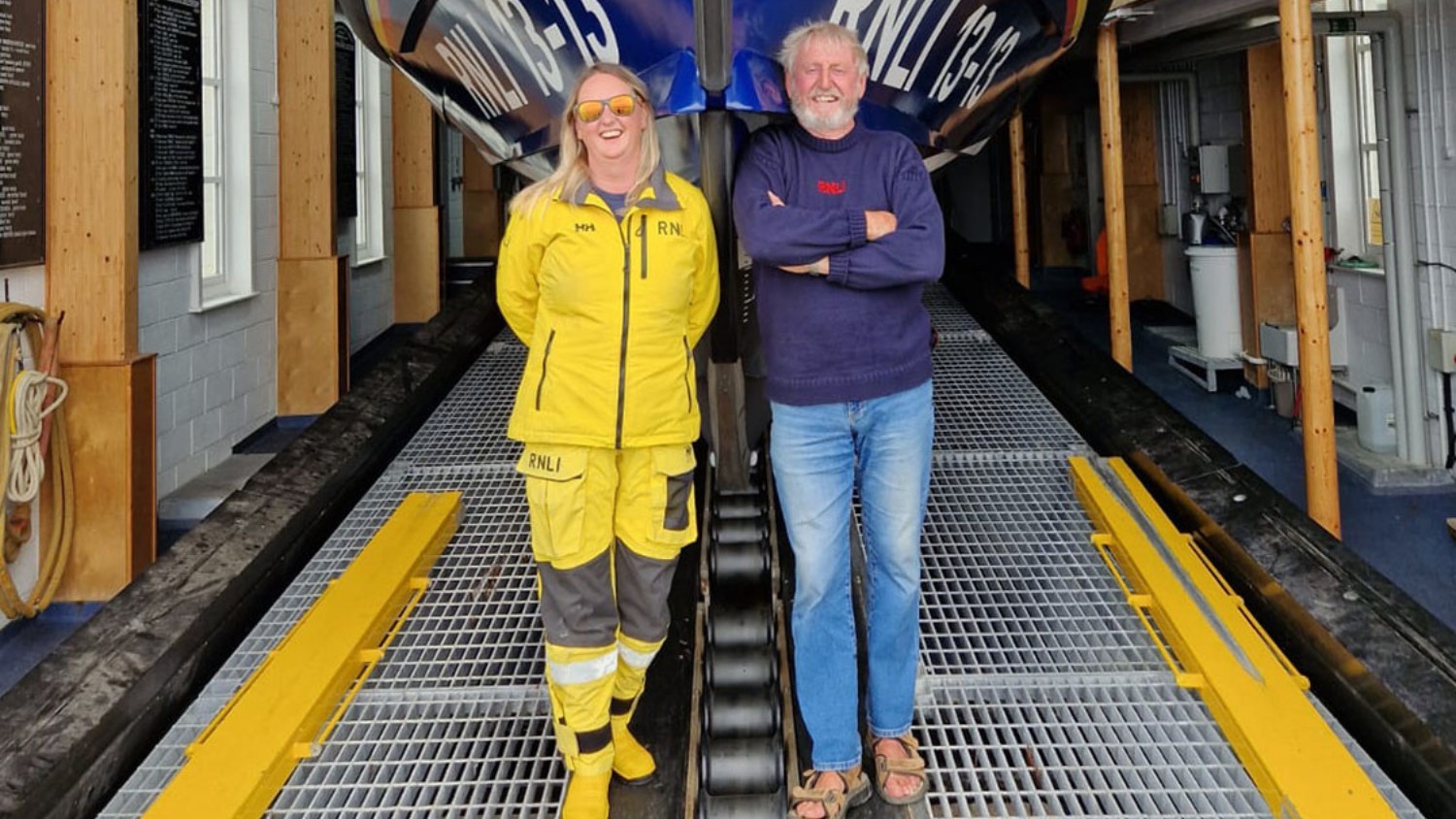 Swanage RNLI lifeboat RNLI 13-13 in boathouse with Alice Haw, newly qualified ILB Helm, and her dad, retired coxswain Christopher Haw.