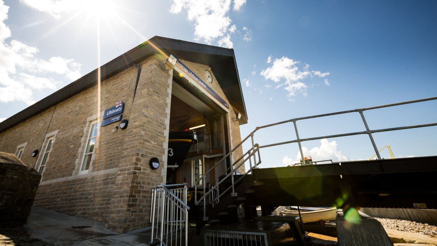 The exterior of Swanage RNLI Lifeboat Station with lifeboat 13-13 just visible inside