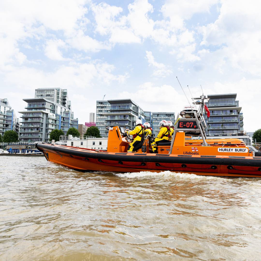 An E class lifeboat and its crew on the River Thames at Wandsworth Riverside Pier.