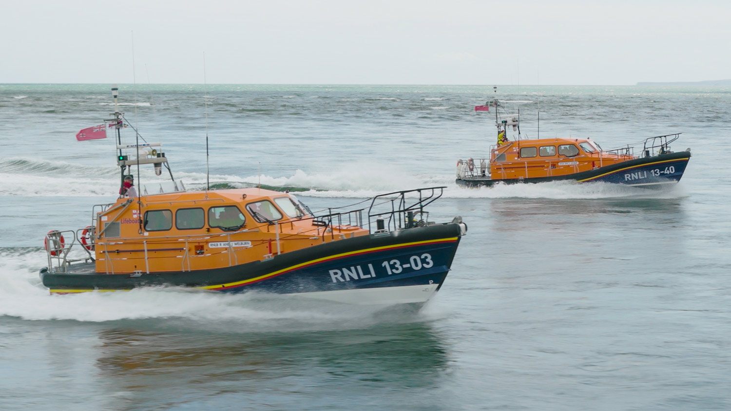 Eric's Legend Shannon class Launch A Memory lifeboat cruises alongside Exmouth’s Shannon class lifeboat on calm seas