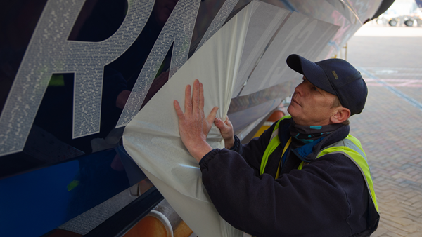 An RNLI technician applying the lifeboat number RNLI 13-44 to the hull of the first legacy lifeboat. The number contains thousands of generous supporters’ names who all left a gift in their Will to the RNLI.