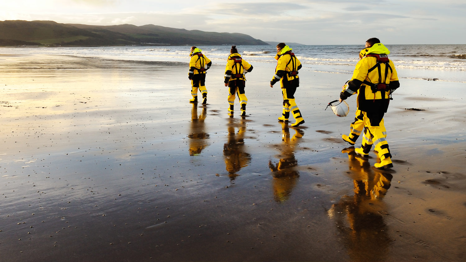 Girvan Lifeboat crew walk along beach