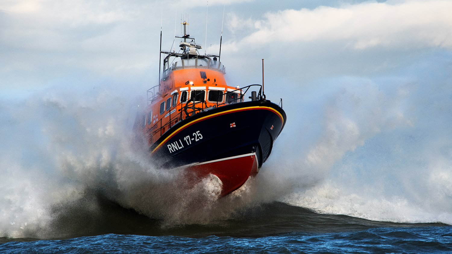 Yarmouth Severn class lifeboat in large waves with lots of white spray