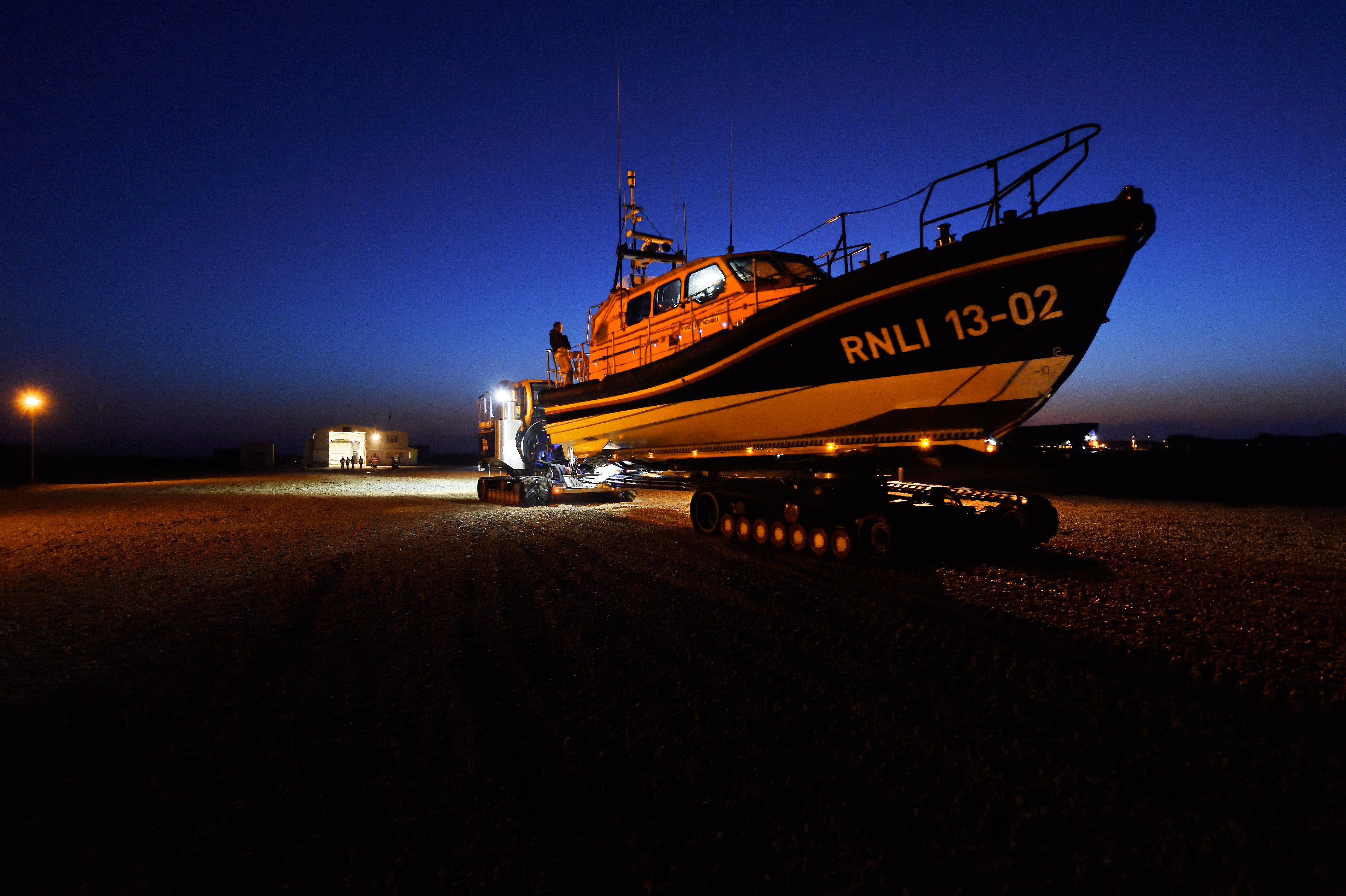 Dungeness RNLI’s Shannon class lifeboat on the Shannon Launch and Recovery Vehicle in the dark.