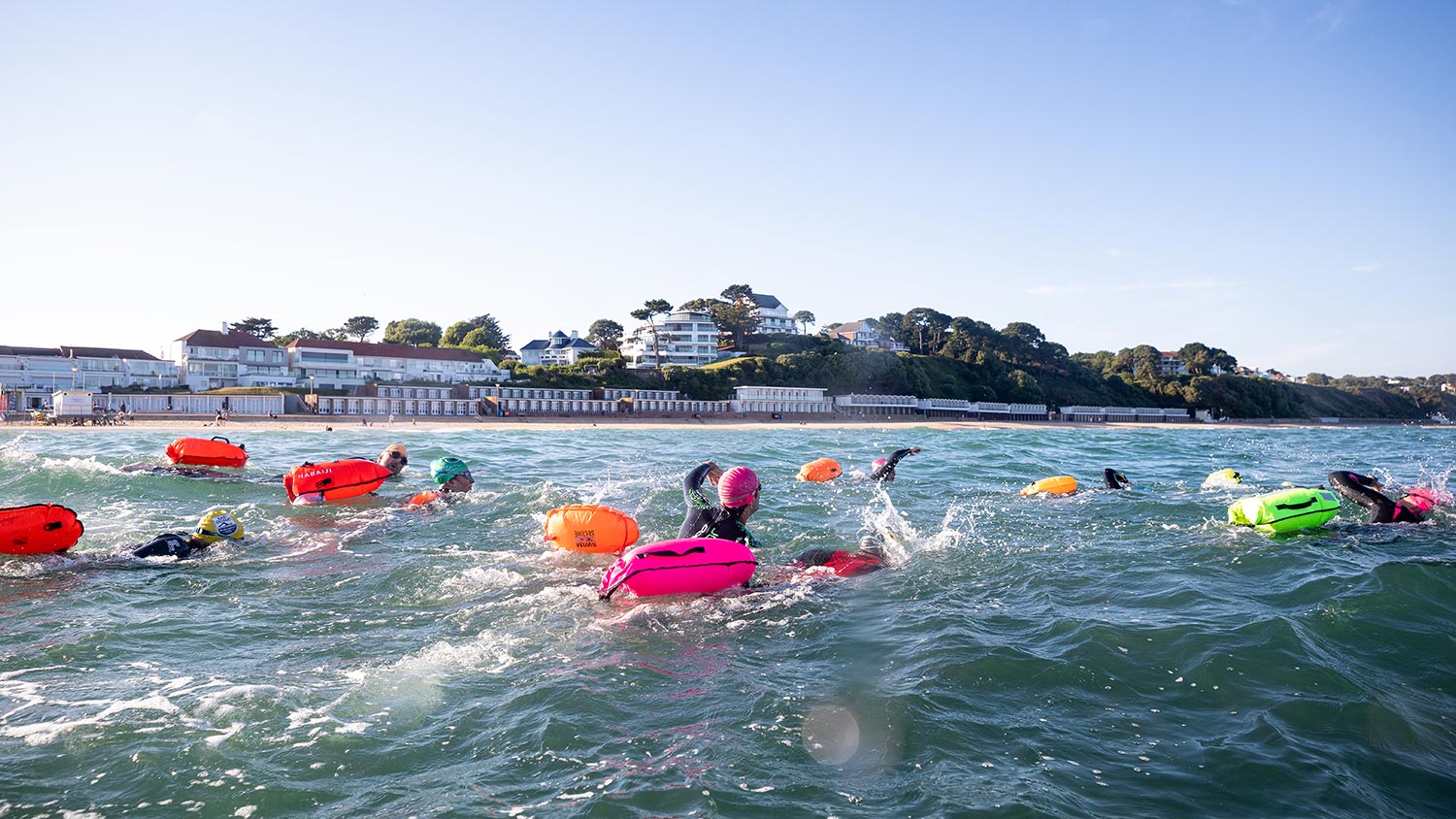 A group of swimmers with buoyancy aids in the sea