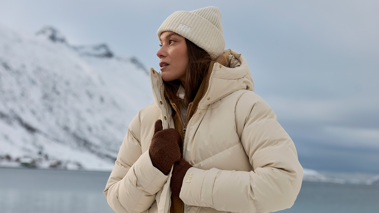 A person in an icy environment, wrapped up in Helly Hansen winter clothing.