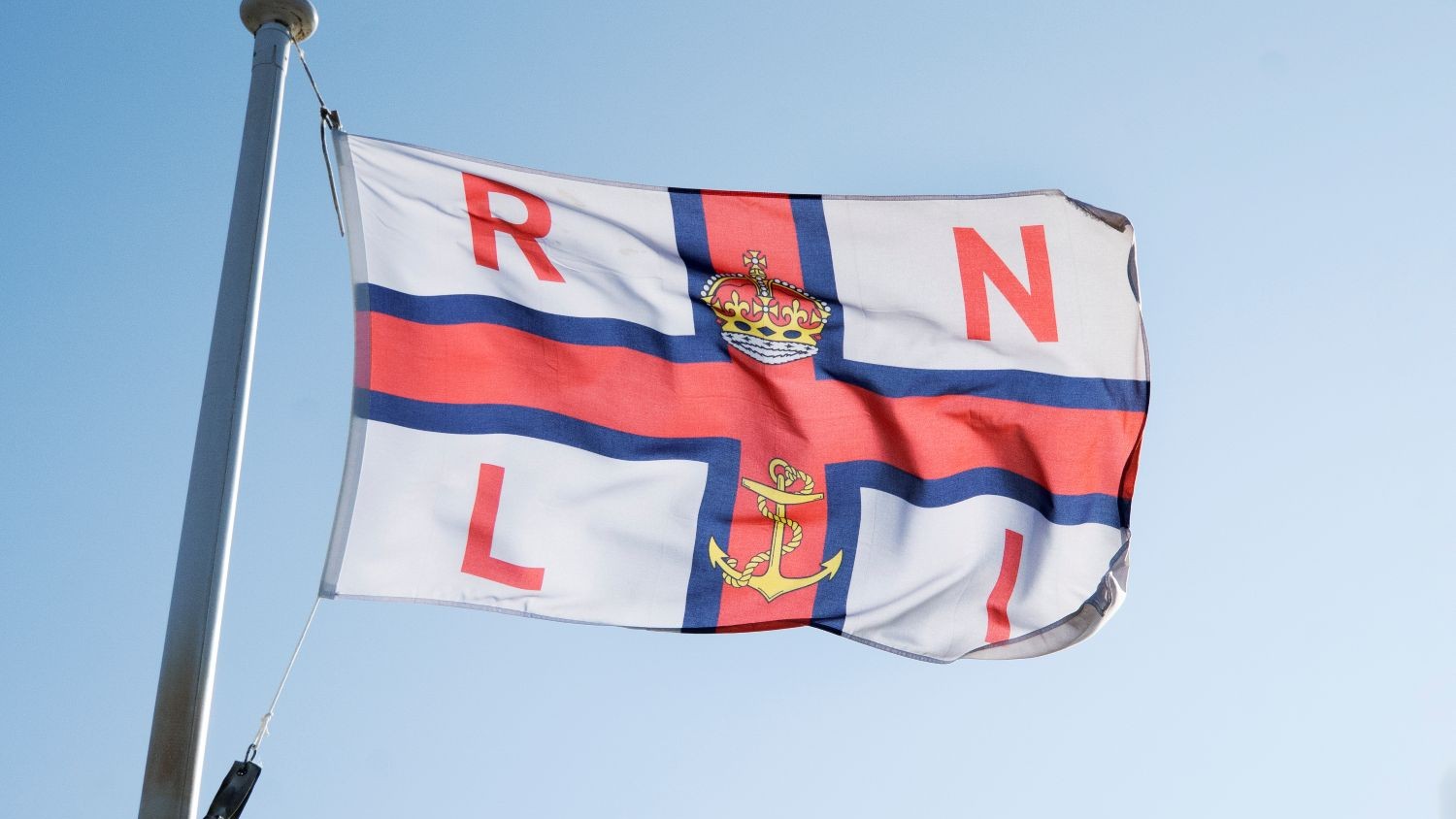 An RNLI flag flying in the breeze