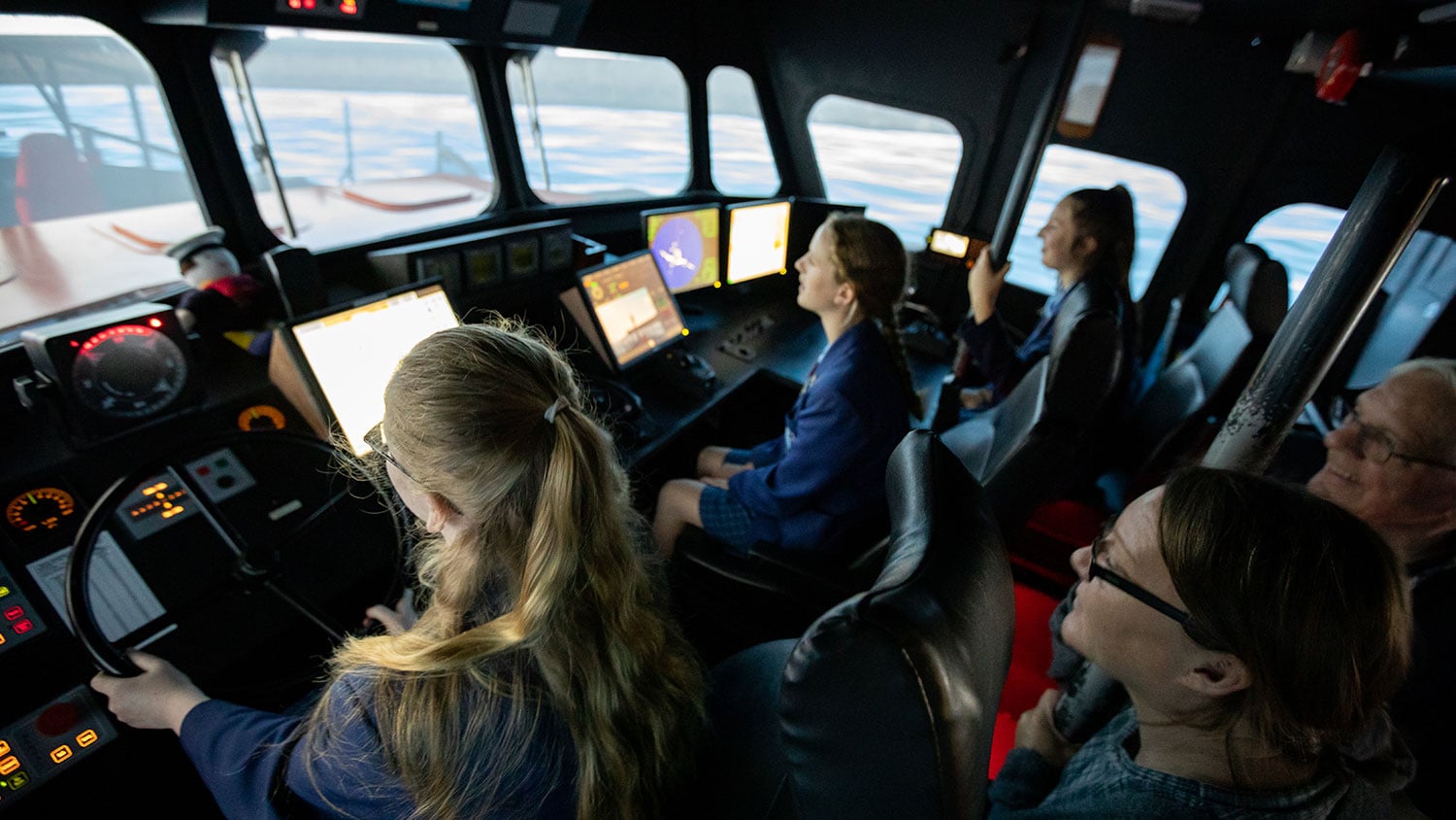 Girls sitting inside a lifeboat