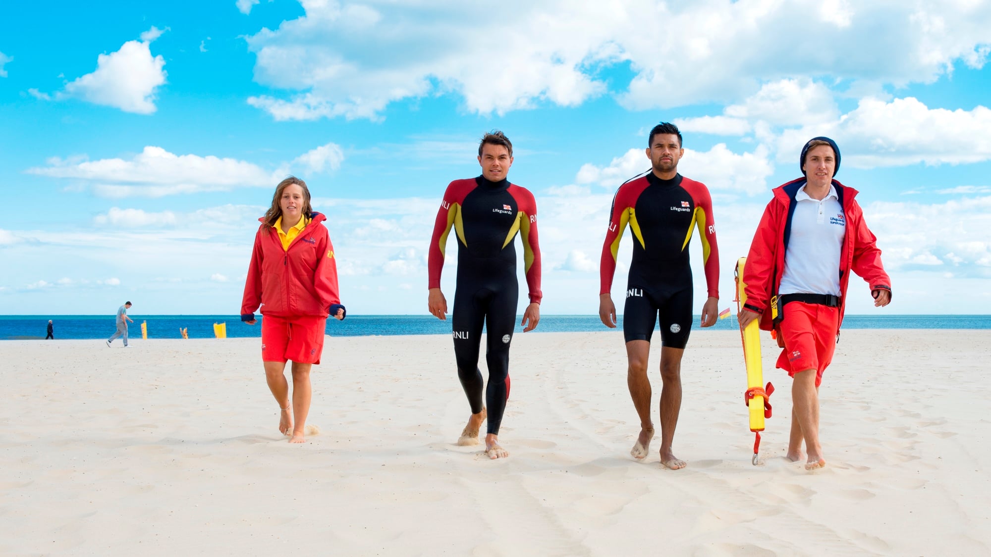 RNLI lifeguards in North Norfolk walk along the beach